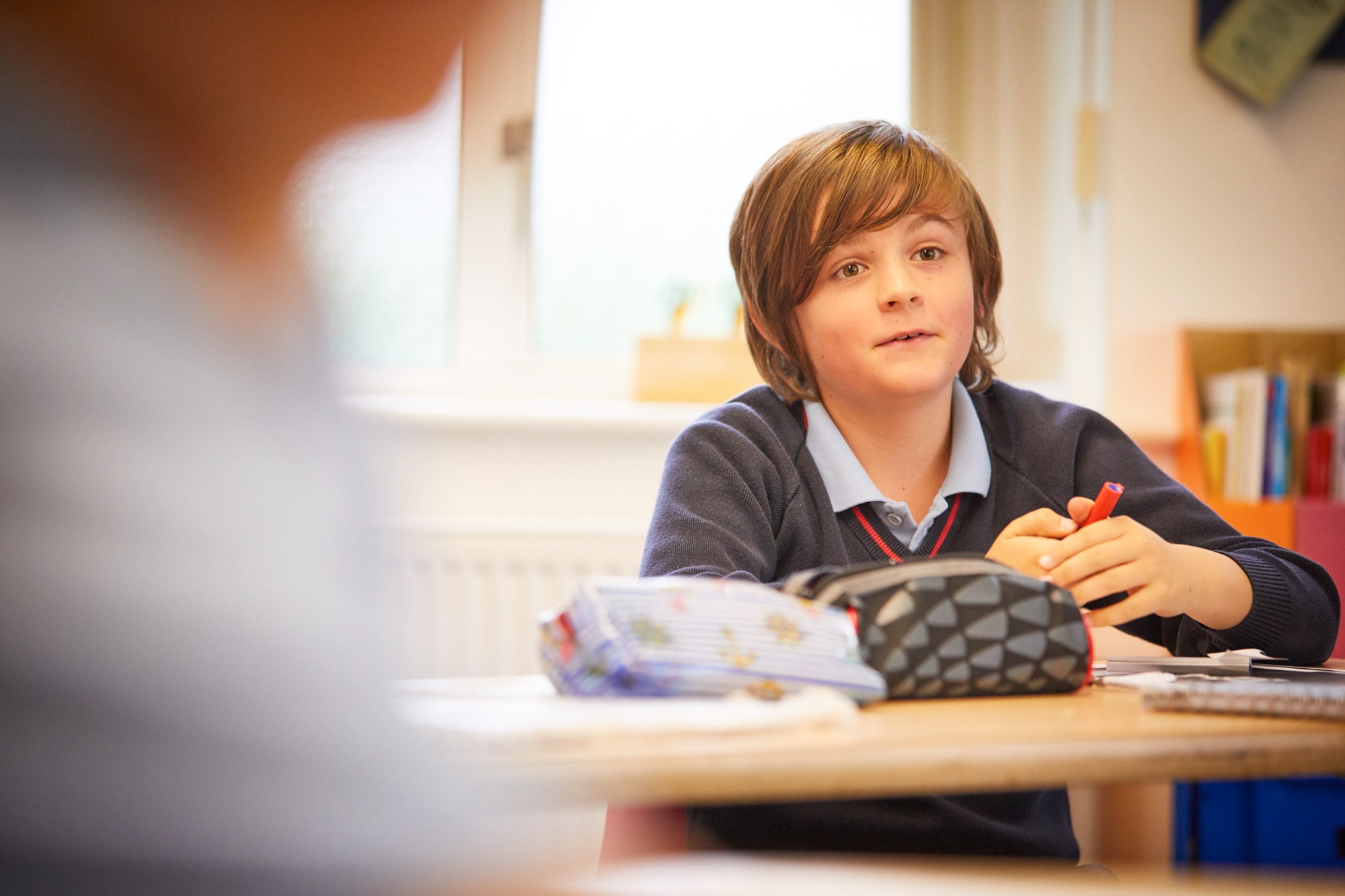 Image of pupil in class to illustrate link to 'Geography' page