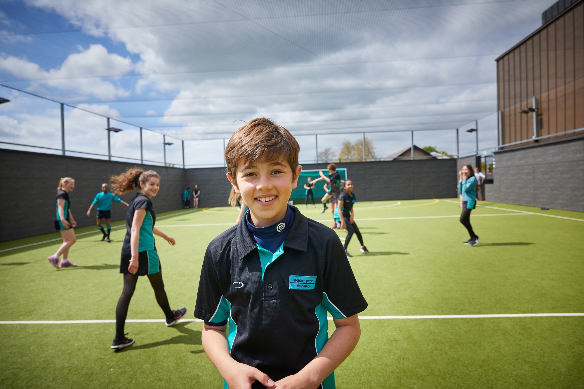 Image of student on football pitch to illustrate link to 'Our Vision' page