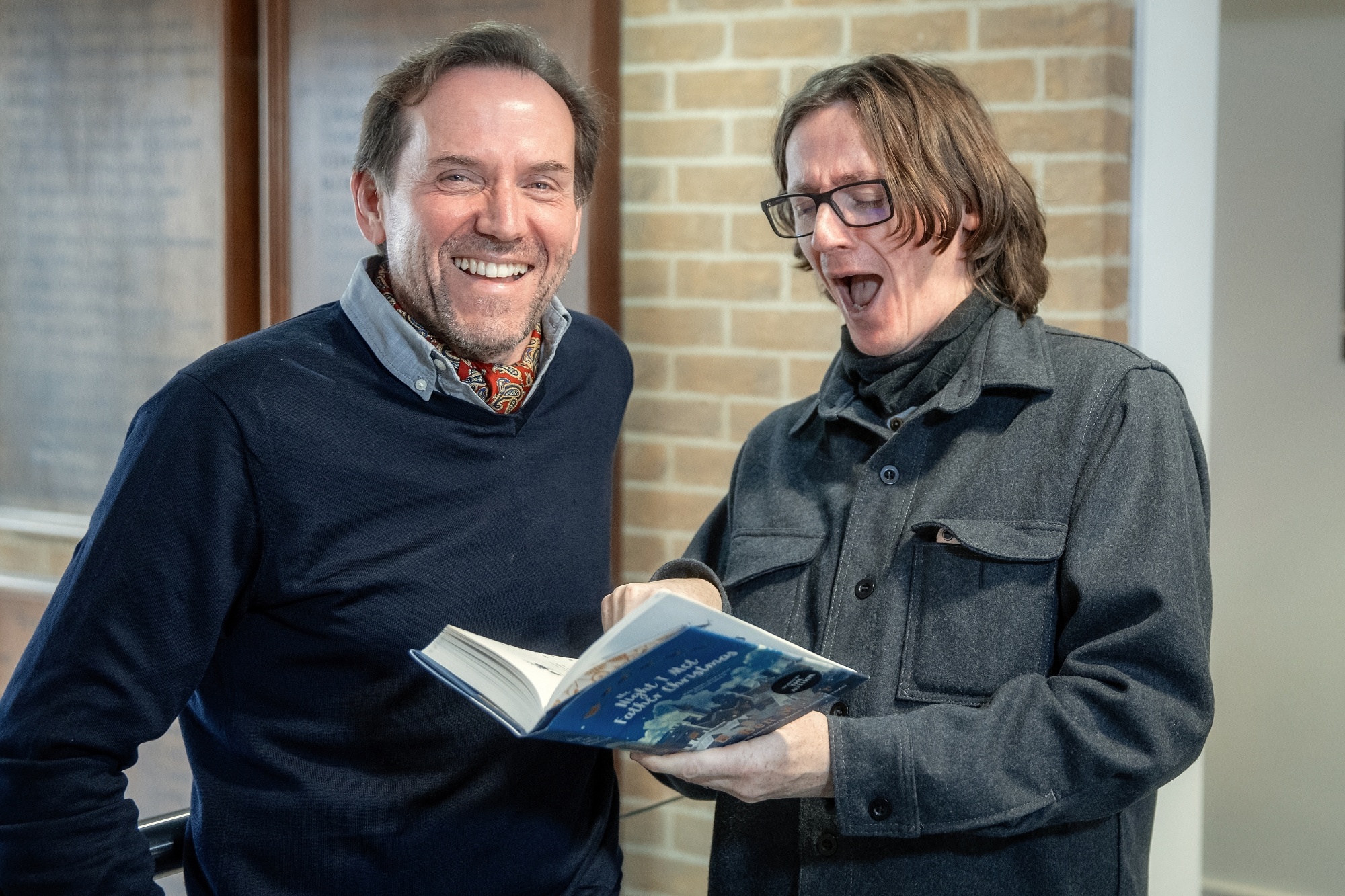 Ben Miller and Ed Byrne look at a copy of Ben's new book