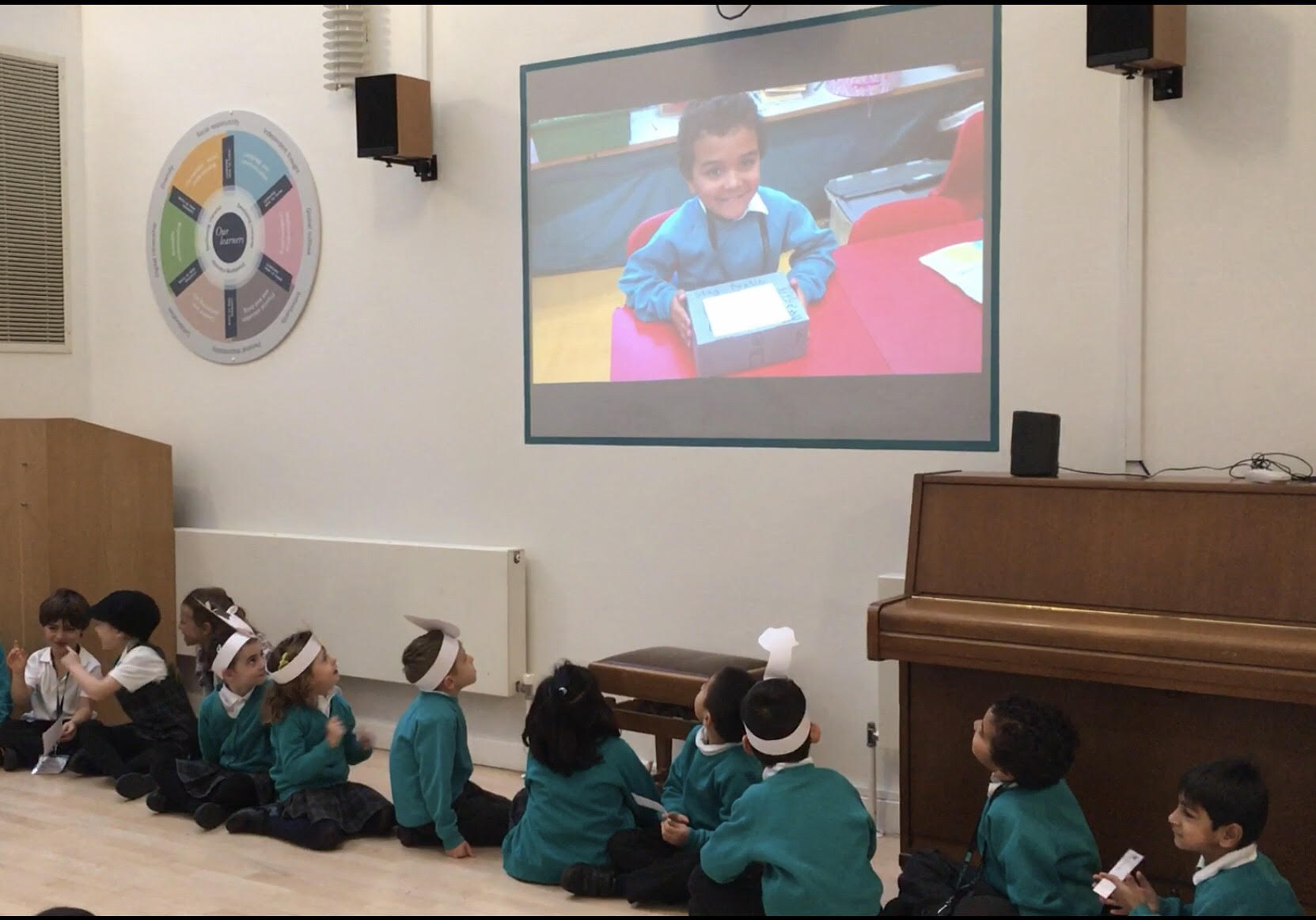 Year 1 watch the screen during their class assembly