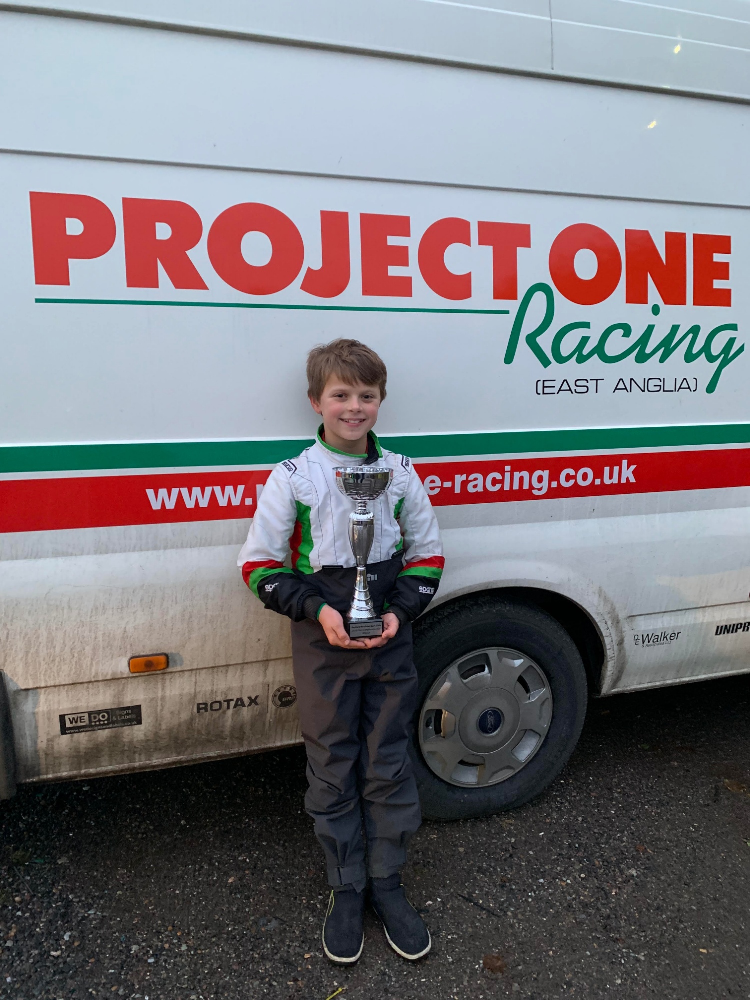 Rylan with his trophy in front of the Project One van