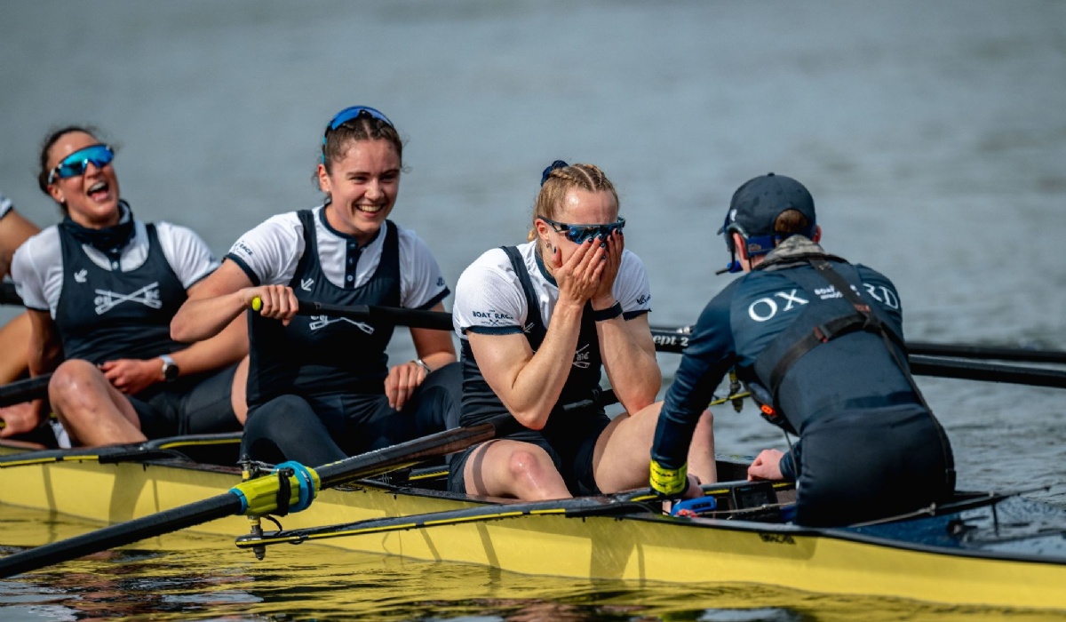 4 members of the Oxford University Women's Boat Race team are seen in their boat after the race end, celebrating their win. 